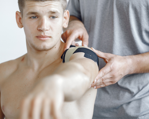 man having shoulder professionally strapped